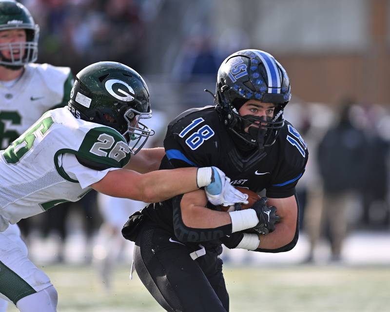 Lincoln-Way East's Jimmy Curtin (18) protecting the ball after catching a pass during the IHSA Class 8A Semifinals on Saturday, November 19, 2022, at Frankfort.