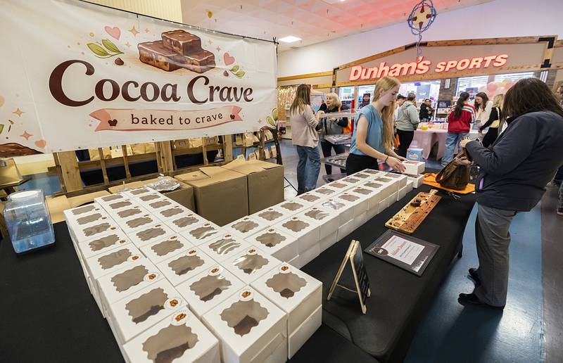 Addison Janssen, a Milledgeville High School senior, sells a box of her brownies to a customer Wednesday, April 29, 2026, at the WACC CEO class trade show. The show is the final step in the class where the students develop a business model to sell their goods or services.