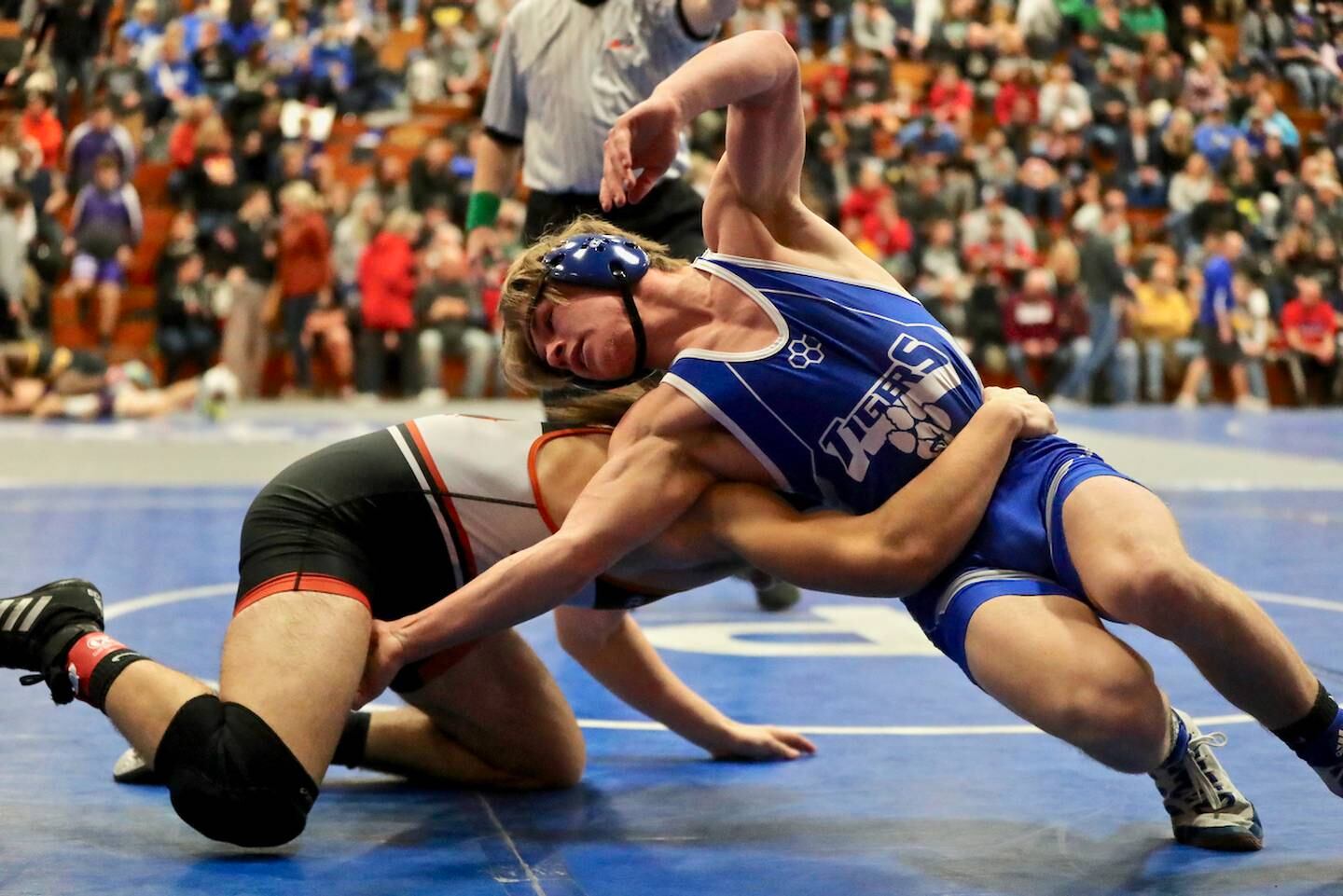 Carson Etheridge turns to get a grip on Sandwich's Bryce Decker in Friday night's wrestling at the Class 2A Princeton Sectional at Prouty Gym.