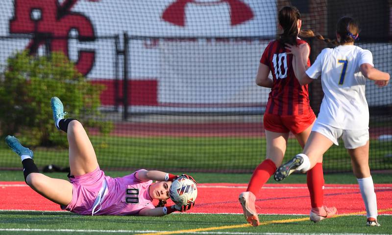 Hinsdale Central goalkeeper Emeline McClenahan (00) makes a diving save during a game against Lyons Township on April 29, 2025 at Hinsdale Central High School in Hinsdale.