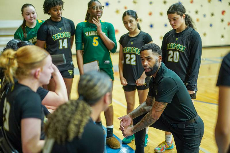 Waubonsie Valley's head coach Brett Love talks to his players during a basketball game against Aurora Central Catholic at Aurora Central Catholic High School on Thursday, January 30, 2025.