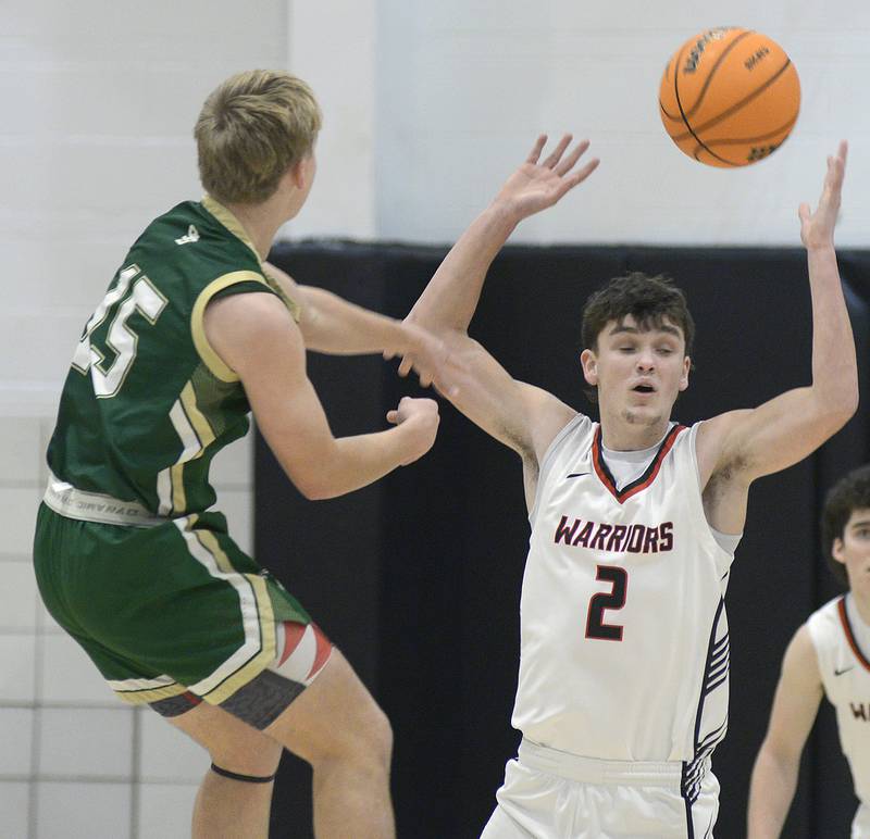 St Bed’s Genoa Dinges  gets this pass through the arms of Woodland’s Nolan Price in the 2nd quarter Friday at Woodland.