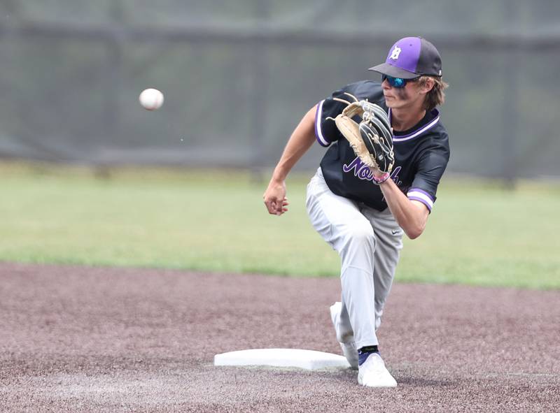 Downers Grove North's Jude Warwick (13) warms up between innings during the IHSA Class 4A baseball regional final between Downers Grove North and Hinsdale Central at Bolingbrook High School on Saturday, May 27, 2023.