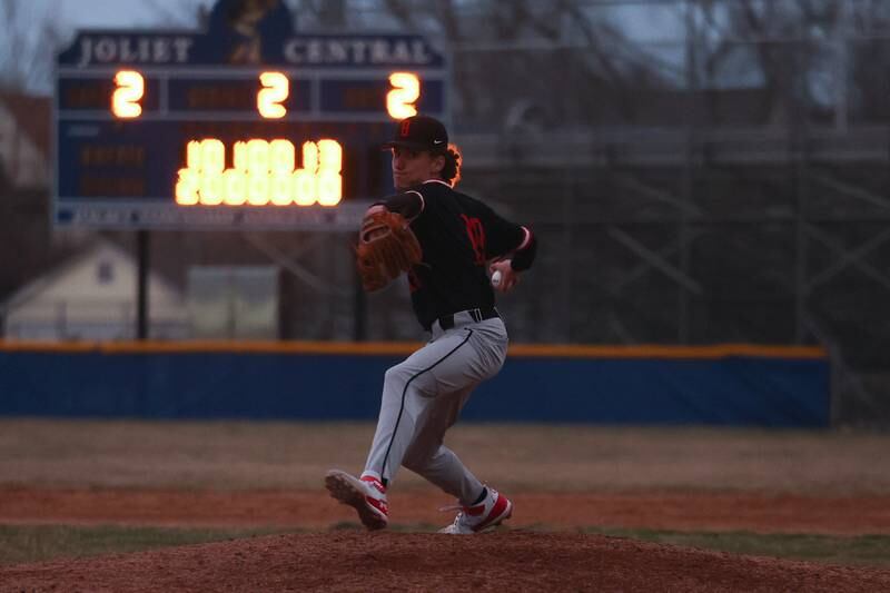 Darkness starts to set in as Bolingbrook’s Holden Burokus delivers the final pitch in a 6-2 win over Joliet Central on Tuesday, March 21st. 2023.