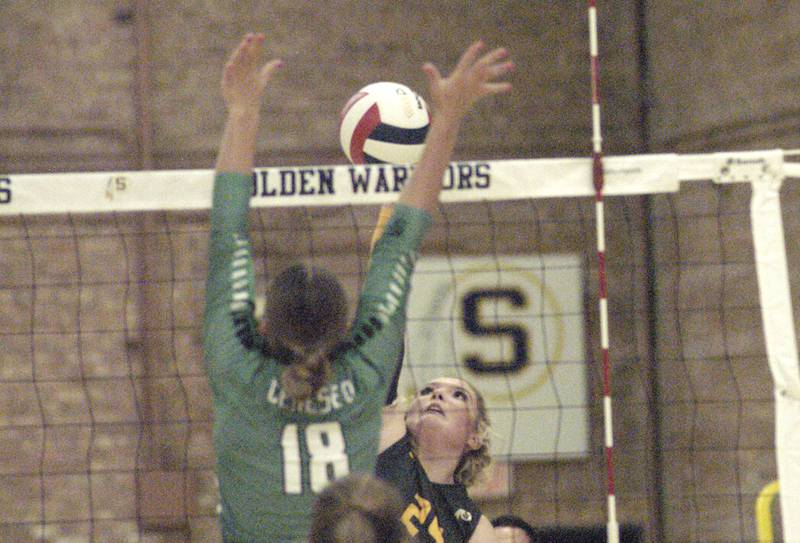 Sterling's Carley Sullivan hits a ball through a Geneseo defender. The action took place at the Sterling vs. Geneseo Volleyball match at Homer Musgrove fieldhouse, on Thursday, Sept. 5, 2024