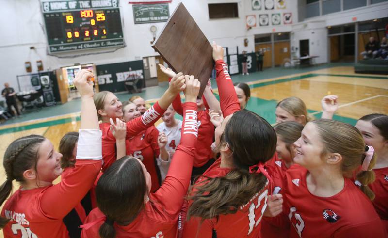 Members of the Henry-Senachwine volleyball team hoist the Class 1A Regional plaque after defeating St. Bede on Thursday, Oct. 31, 2024 at St. Bede Academy.