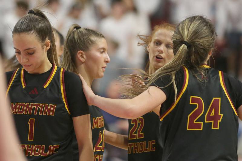 Montini Catholic players support teammate Nikki Kerstein while at the free throw line against Quincy Notre Dame during the Class 3A State semifinal game on Thursday, March 6, 2025 at CEFCU Arena in Normal.