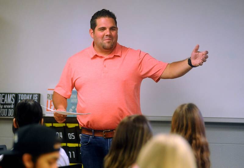 Harvard High School teacher Nick Valenziano teaches about different types of laws during a business law class Wednesday, April 6, 2022.
