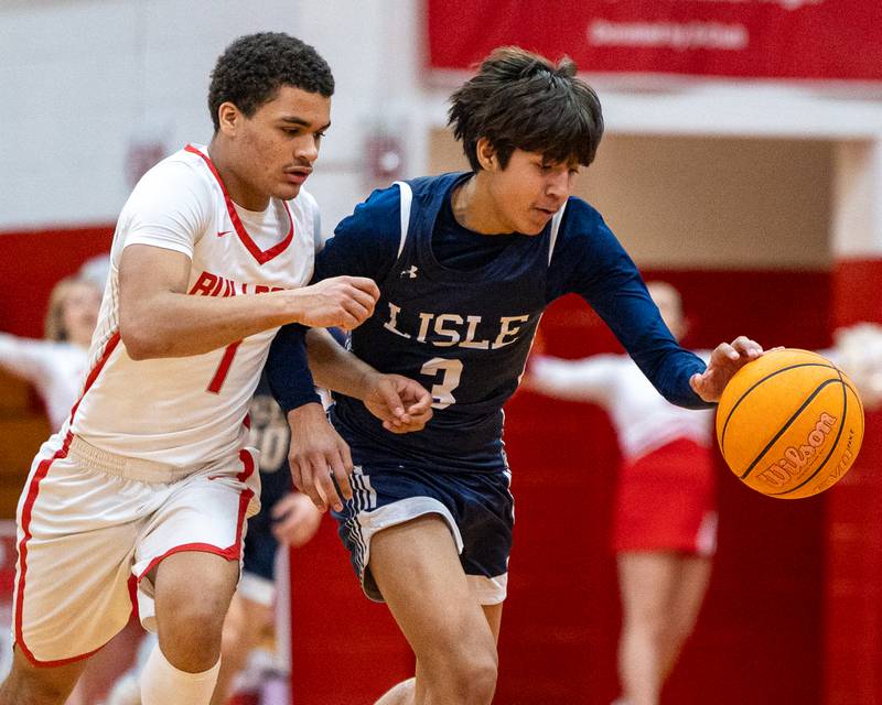 Lisle's Lucas Bundschuh (3) dribbles ball as Lazyeric Moton (1) of Streator guards at hip on Wednesday, Feb. 18, 2026 at Streator High School in Streator.