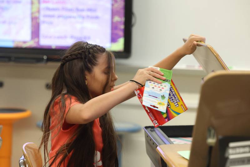 5th grader Abigail Almazan Ortiz puts school supplies in her desk on the first day of school at Woodland Elementary School in Joliet. Wednesday, Aug. 17, 2022, in Joliet.