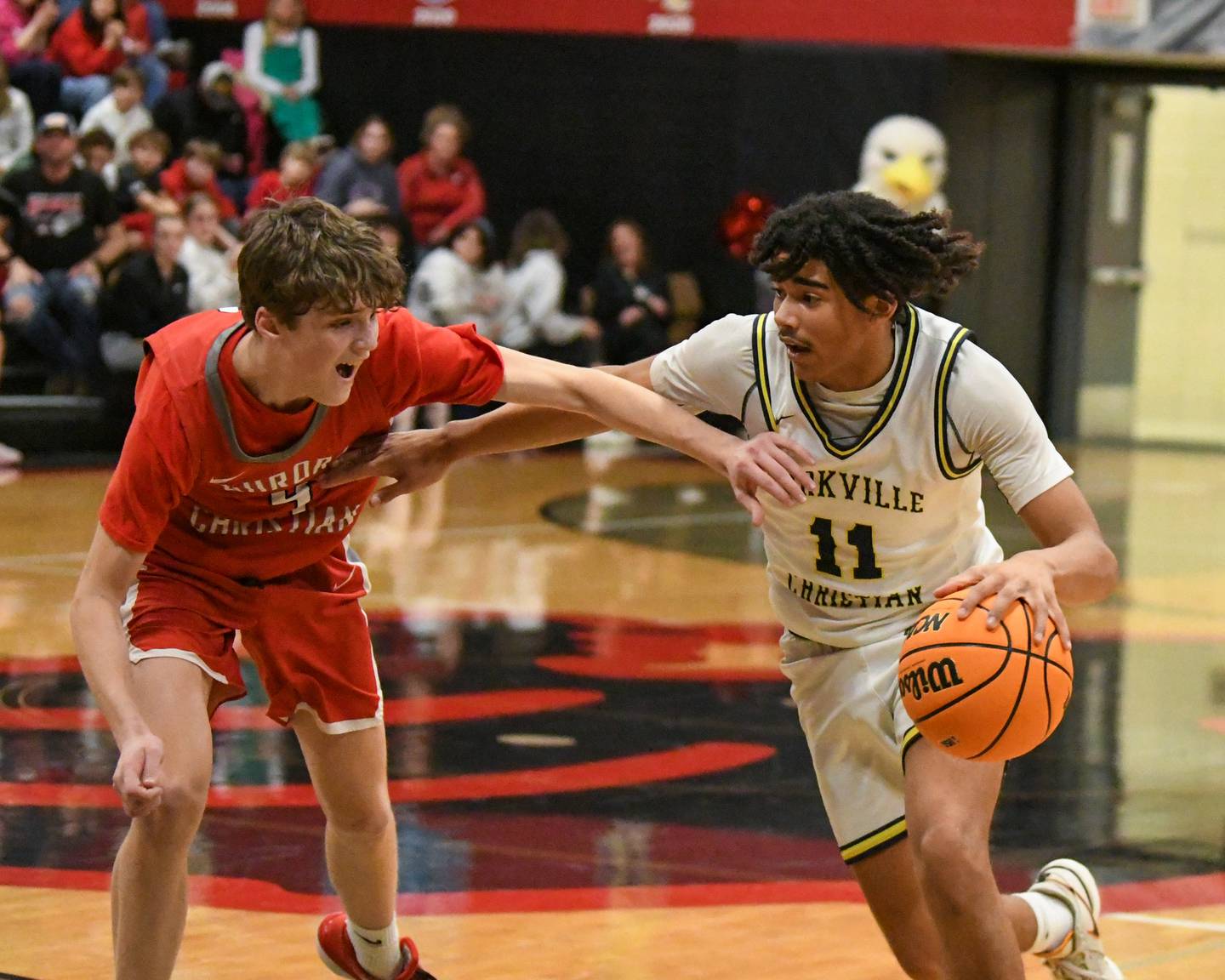 Yorkville Christian's Kayden Maxwell (11) tries to get around Aurora Christian's Joe DeCort (4) during the regional title game on Friday Feb. 28, 2025, held at Indian Creek High School.