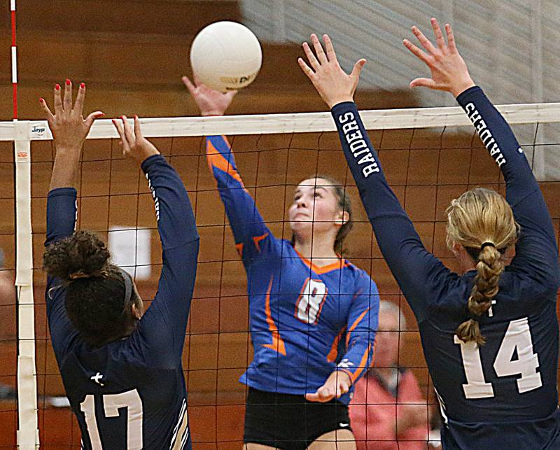 Genoa-Kingston's Alivia Keegan (8) spikes the ball between Quincy Notre Dame's Laela Hernandez-Jones and teammate Abbey Schreacke (14) in the first match of the Class 2A Supersectional volleyball game on Friday, Nov. 4, 2022 at Princeton High School.