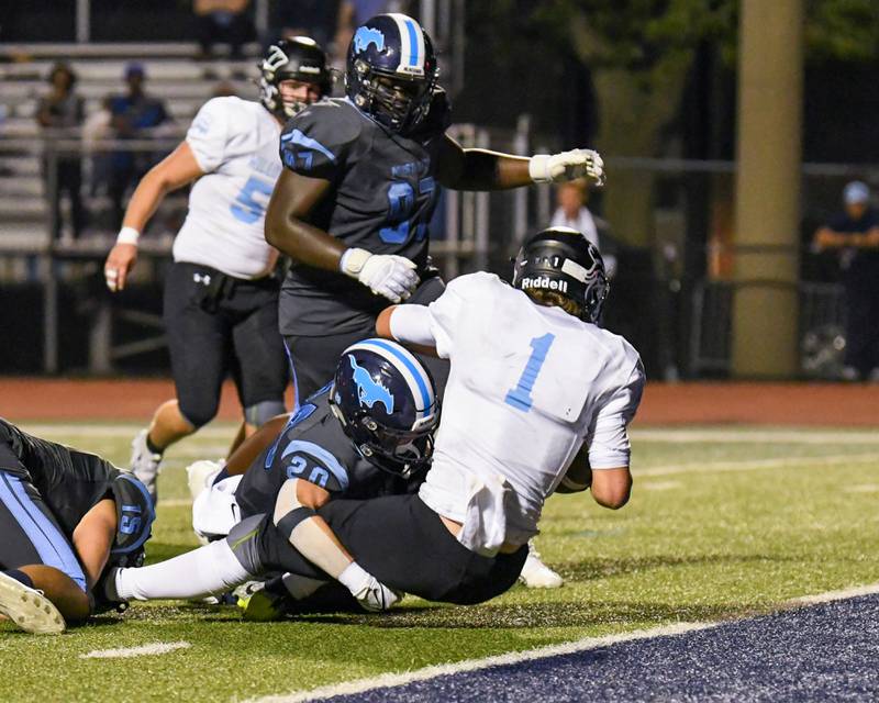 Downers Grove South’s Coen Godenschwager (20) takes down Willowbrook’s Arthur Palicki (1) as Arthur crosses the line for a touchdown in Downers Grove on Friday Sep. 15, 2023,