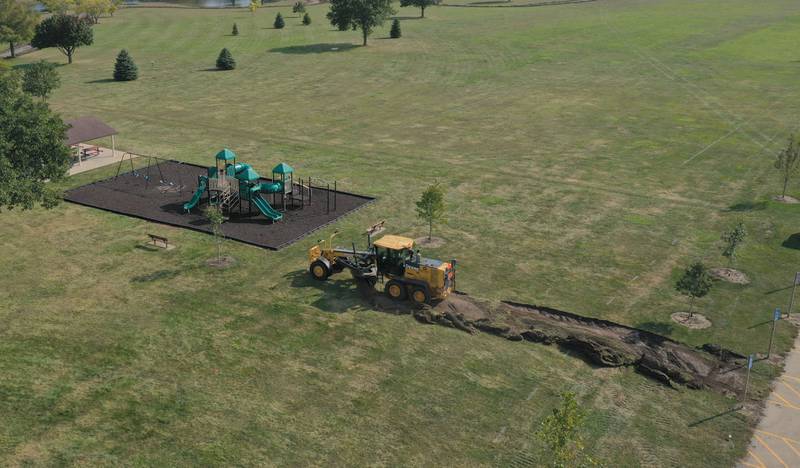 A road grader begins to make a new pathway to the playground at Baker Lake in Peru. Crews are replacing the old walking path with a new one. The Peru City Council approved of the project last month. Gillan Construction out of Cherry was the winning bid to do the project for just under $300,000. The city will use a credit from Mertel Gravel of about $200,000 to pay for materials.

The resurfacing work will include a 10-foot wide concrete path with secondary concrete paths also added, connecting with the new parking lot near Lighted Way and connecting with the parking lot, playground, and shelter on the west side of Baker Lake. The park is closed to the public until early December.