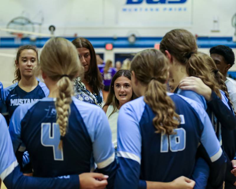 Downers Grove South's head coach Madison Babich instructs the team during a timeout in their match versus Downers Grove North.  Sept 7, 2023.