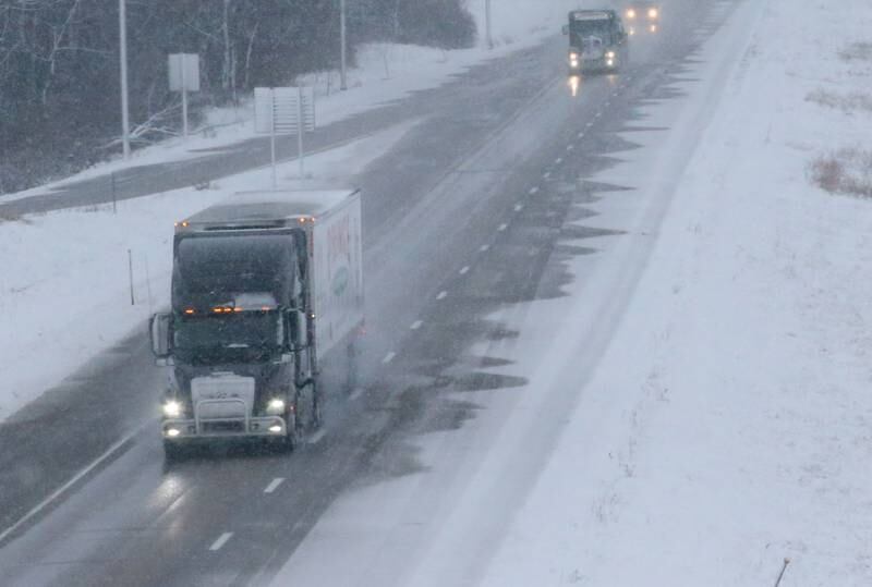 Semi trucks navigate Interstate 80 in the snow on Tuesday, Jan. 9, 2024 in Bureau County.