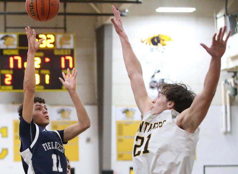 Fieldcrest's Jozia Johnson shoots a shot over Putnam County's Orlando Harris on Tuesday, Feb. 7, 2023 at Putnam County High School.