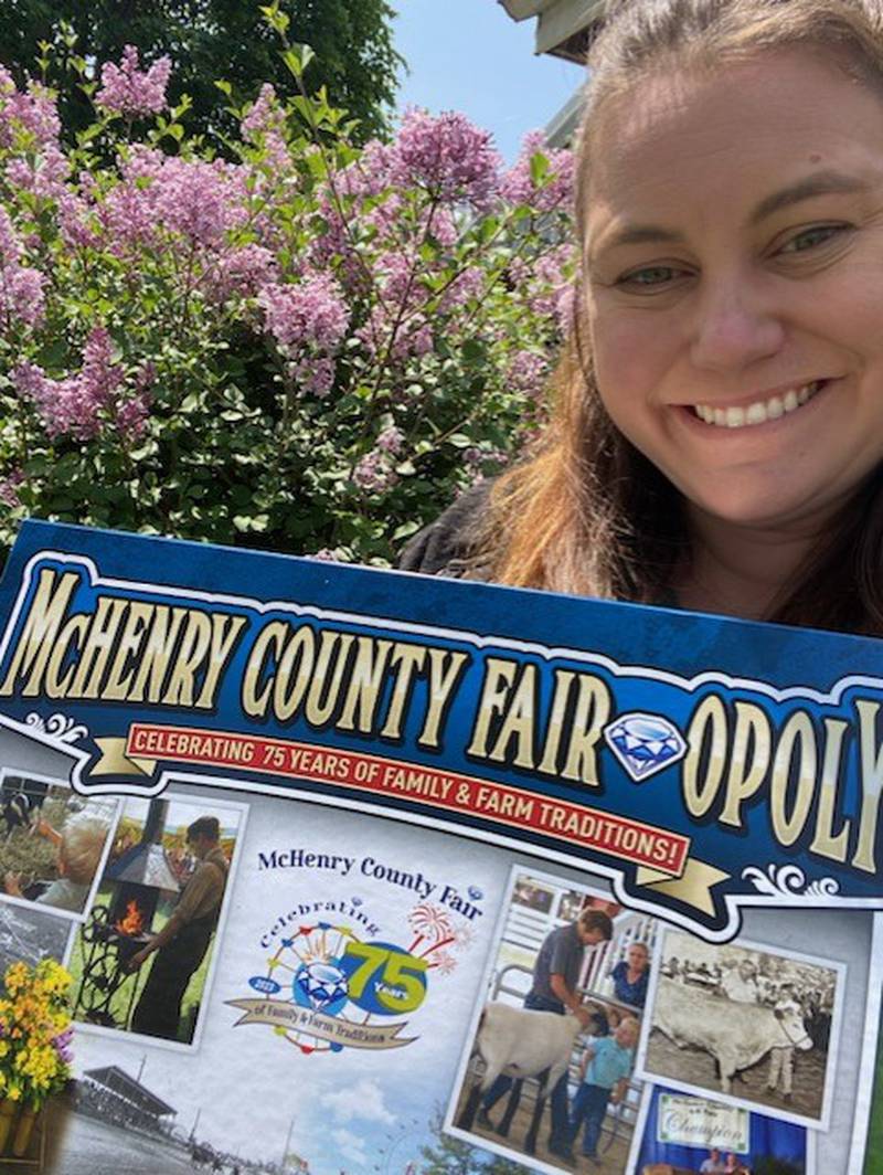 Hannah Rinn, with the McHenry County Fair, holds a photo of the new 'Monopoly' board that is based on the fair, May 22, 2023.