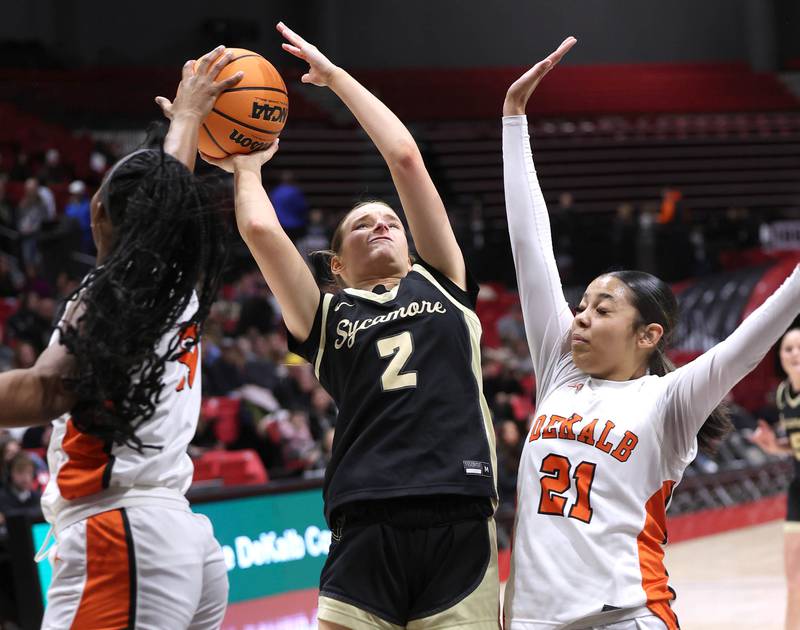 Sycamore's Sydney Fabrizius tries to shoot between DeKalb's Johnna Patrick (left) and Alicia Johnson Friday, Jan. 30, 2026, during their game in the FNBO Challenge in the Convocation Center at Northern Illinois University in DeKalb.