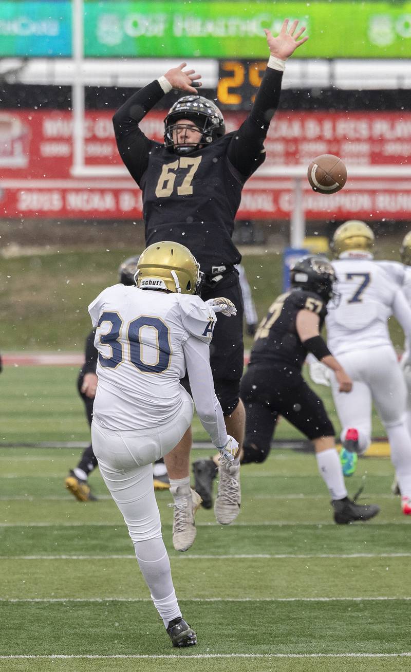 Lena-Winslow's Gannon Dunker goes up to block a Althoff Catholic’s Austin Wilkinson punt Friday, Nov. 29, 2024, in the class 1A football state final.