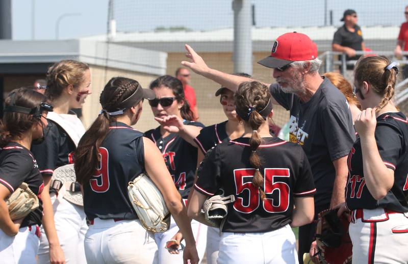 Benet Academy head coach Jerry Schilf talks to his team on the mound against Charleston during the Class 3A State third place game on Saturday, June 10, 2023 at the Louisville Slugger Sports Complex in Peoria.