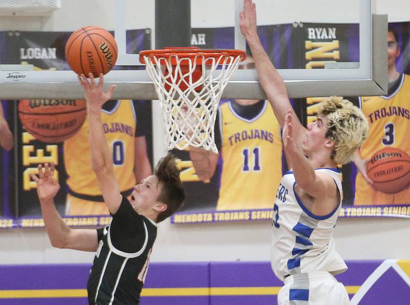 Byron's Ryan Tucker scores on a reverse layup over Princeton's Noah LaPorte during the Class 2A Sectional final on Friday, March 1, 2023 at Mendota High School.