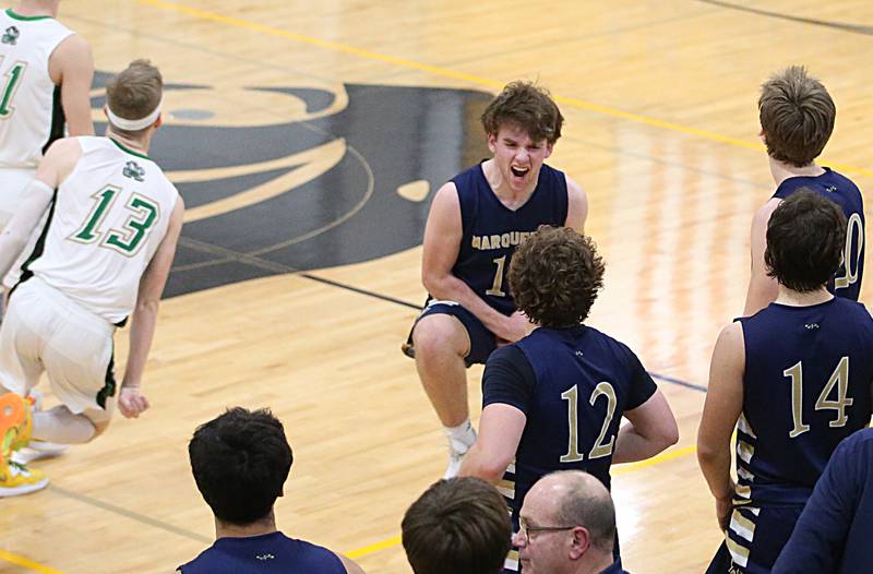 Marquette's Tommy Durdan (top) reacts with teammates after defeating Seneca in the Tri-County Conference championship on Friday, Jan. 27, 2023 at Putnam County High School.