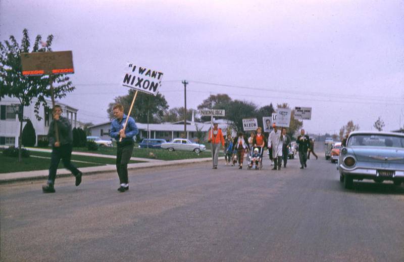 Dennis Millhouse carries an "I Want Nixon" sign during a 1960 Nixon-Lodge campaign parade on Briarcliff Road near Bereman Road in Boulder Hill.