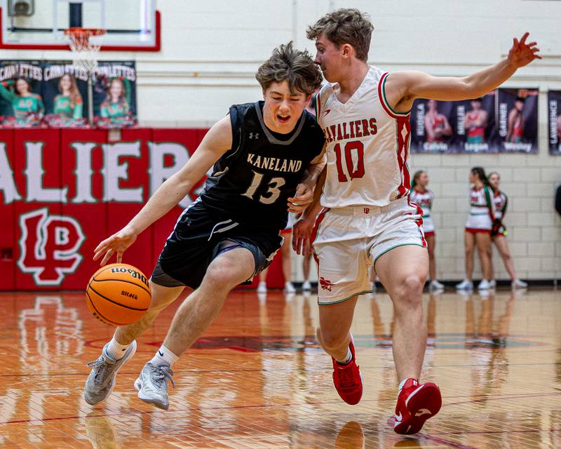 Kaneland's Bryce Goss (13) drives ball down lane as LaSalle-Peru's Kyle Spelich (10) guards at hip on Friday, Feb. 20, 2026 in Sellett Gymnasium at L-P High School.