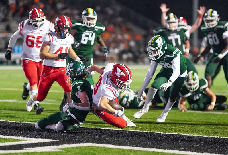 Yorkville's Luke Zook (10) dives in for a score against Plainfield Central's Max Russell (3) during a football game at Plainfield Central High School on Friday, Sept. 15, 2023.