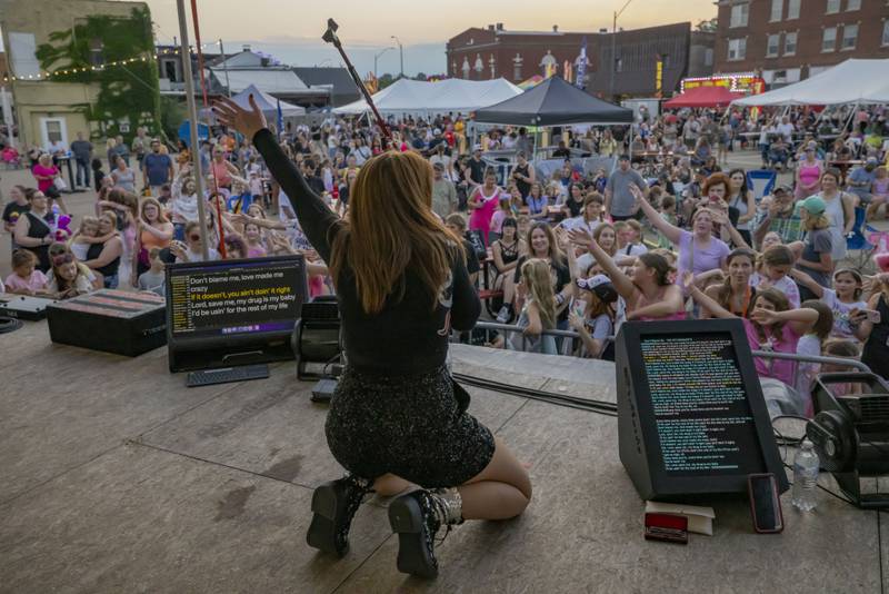 Gina Crosley-Corcoran of Burning Red performs on stage Friday, June 21, 2024, during Celebrate La Salle. Burning Red is a Taylor Swift tribute.