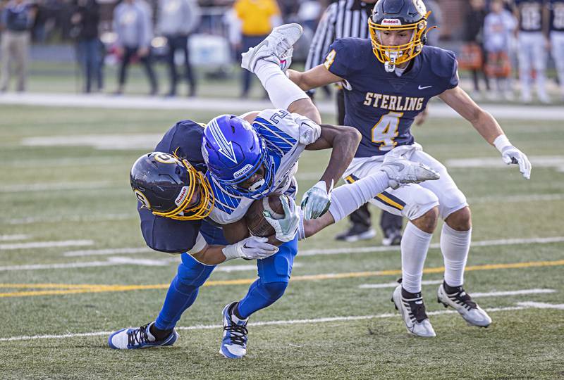 Sterling’s Jimmy Wadsworth hauls down St. Francis’ Ian Willis Saturday, Nov. 4, 2023 in a class 5A playoff game in Sterling.