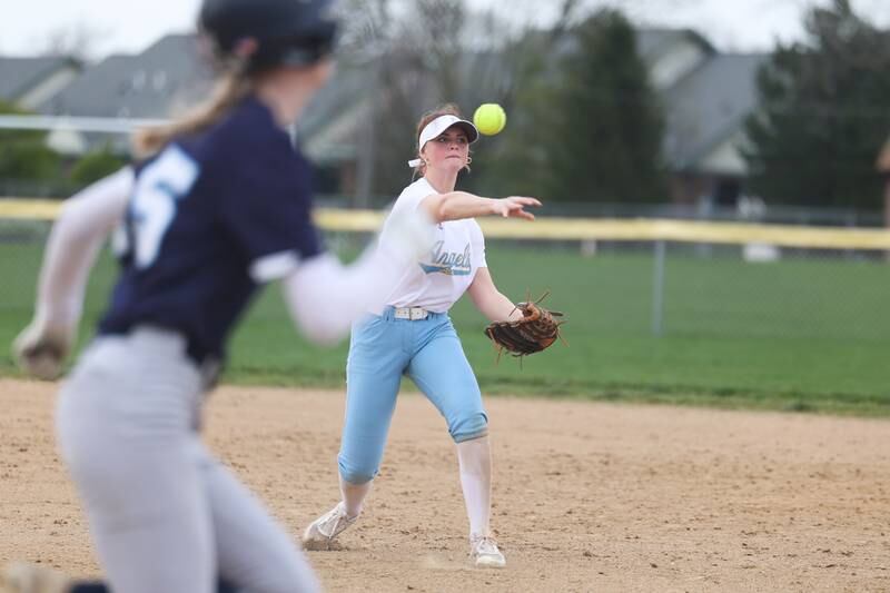 Joliet Catholic’s Molly Ryan throws to first for the out against Plainfield South on Wednesday, April 10, 2024.