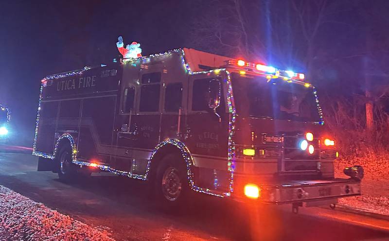 Santa Claus arrives on a Utica Fire engine on Saturday, Dec. 21, 2024 in Utica.