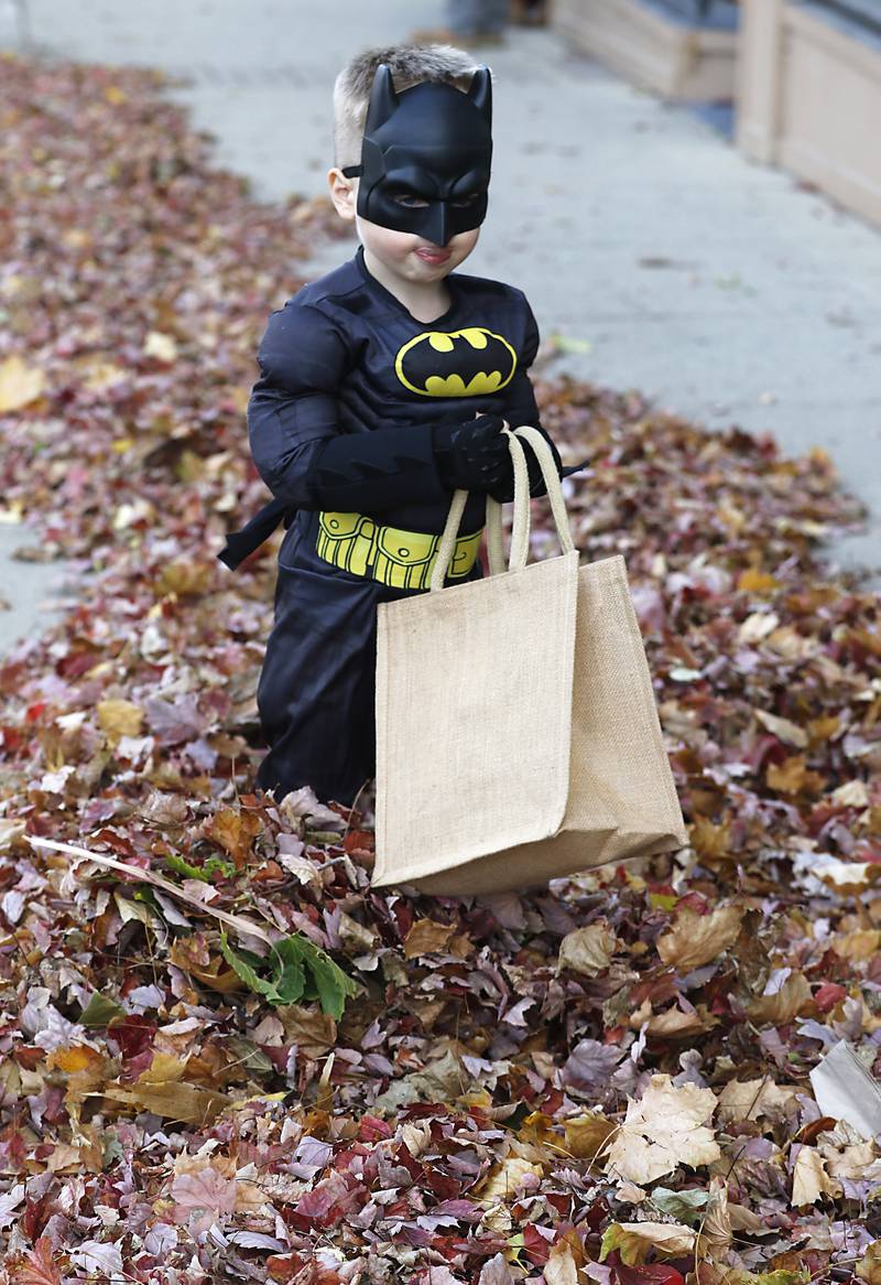 Callum Turner walks through a pile of leaves as he trick or treats during Halloween on the Square on Thursday, Oct. 31, 2024, in Woodstock. The event featured trick and treating and a costume contest.