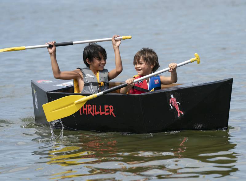 Maddox Spangle (left), 10, of Prairie Grove, along with his brother Justice, 8, participate with their boat Thriller, during the Crystal Lake Cardboard Regatta on Saturday, July 23, 2022 at Main Beach in Crystal Lake. Cardboard took to the lake as a fundraiser for the Crystal Lake Parks Initiative Foundation. Ryan Rayburn for Shaw Local