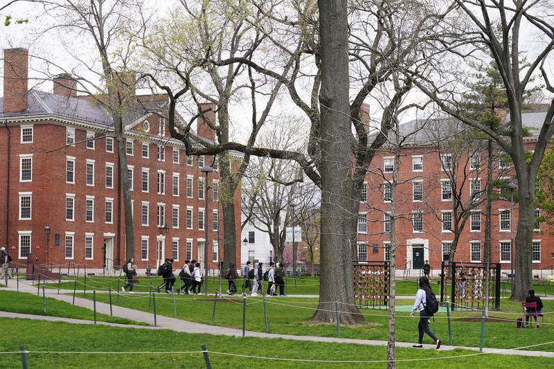 FILE - Students walk through Harvard Yard, April 27, 2022, on the campus of Harvard University in Cambridge, Mass. (AP Photo/Charles Krupa, File)