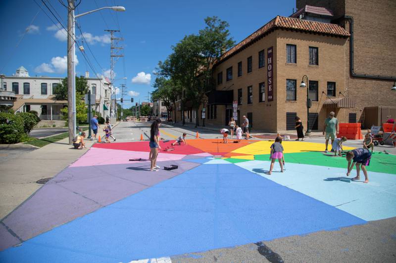 Attendees of the Paint the Riverside event paint the intersection of Riverside Avenue and Walnut Street on Saturday, July 30, 2022.