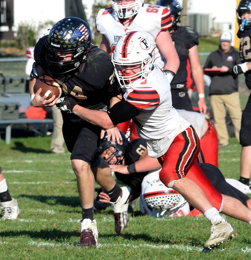 Forreston's Alex Riya (3) wraps up Lena-Winslow's Lucas Fye (24) during second round action of the 1A playoffs at Lena-Winslow on Saturday, Nov. 4, 2023. The Cardinals fell to the Panthers 46-14.