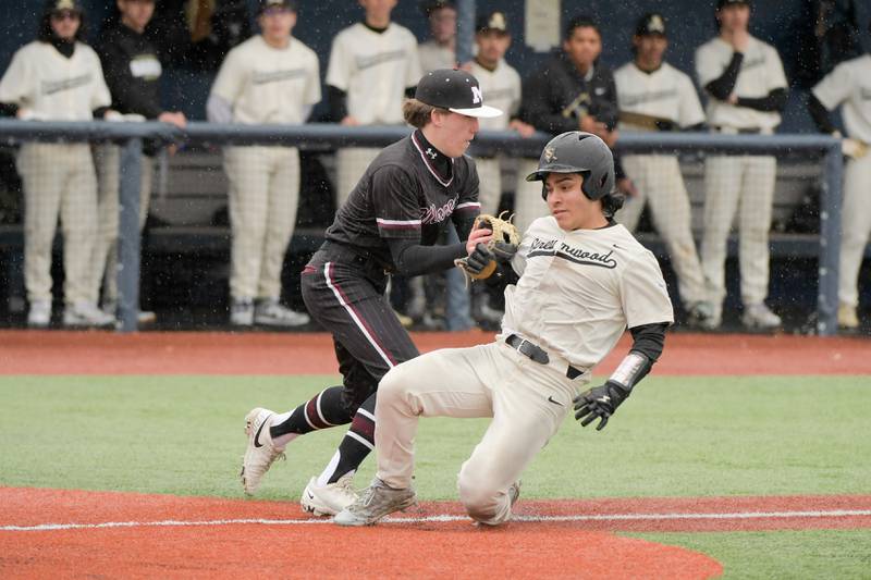 Marengo's Robert Heuser (2) makes the tag on Streamwood's Antonio Alanis (1) for the out during a game on Monday, March 25, 2024 in Carol Stream.