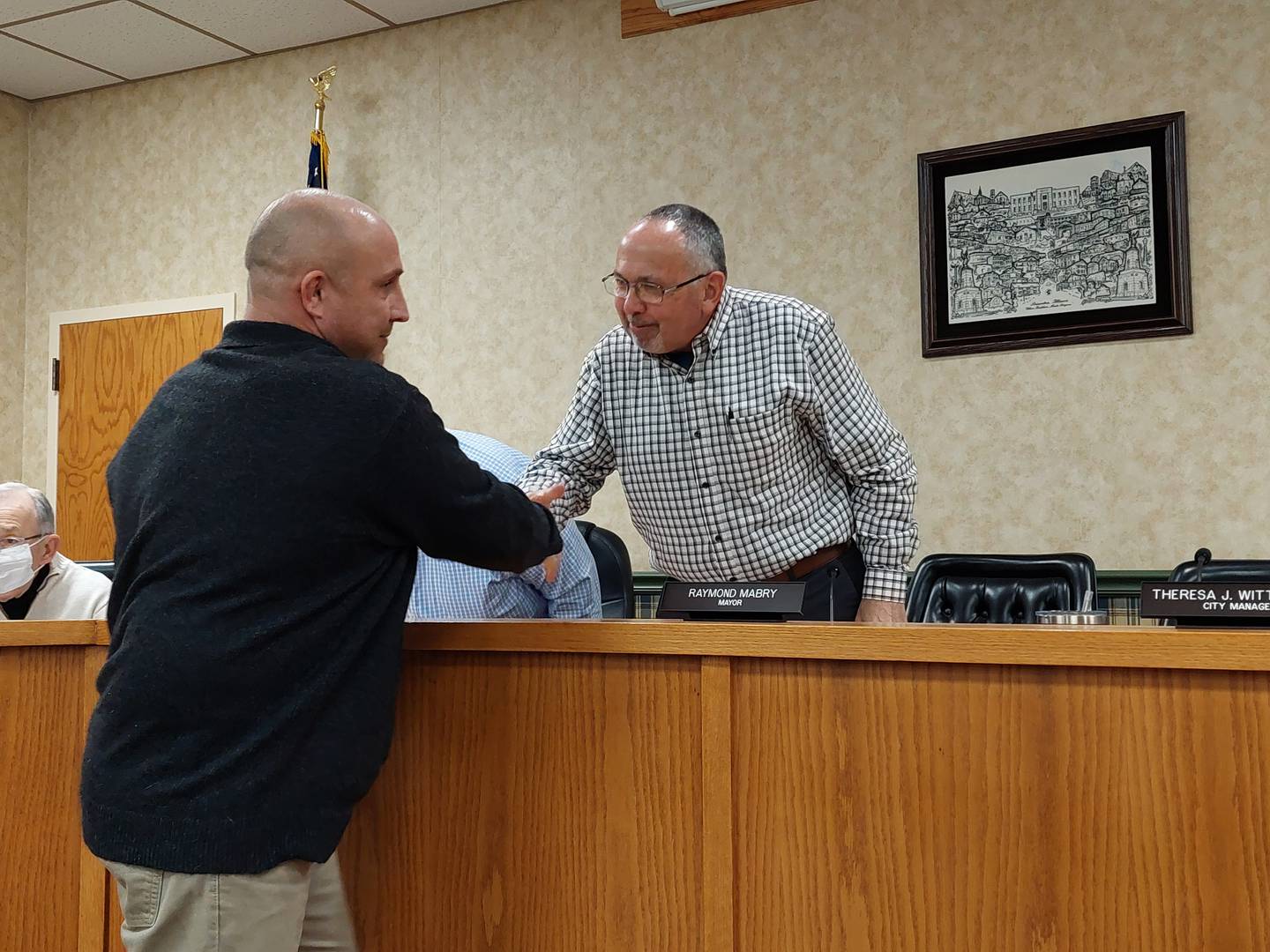 Princeton Mayor Ray Mabry congratulates Aaron Christensen