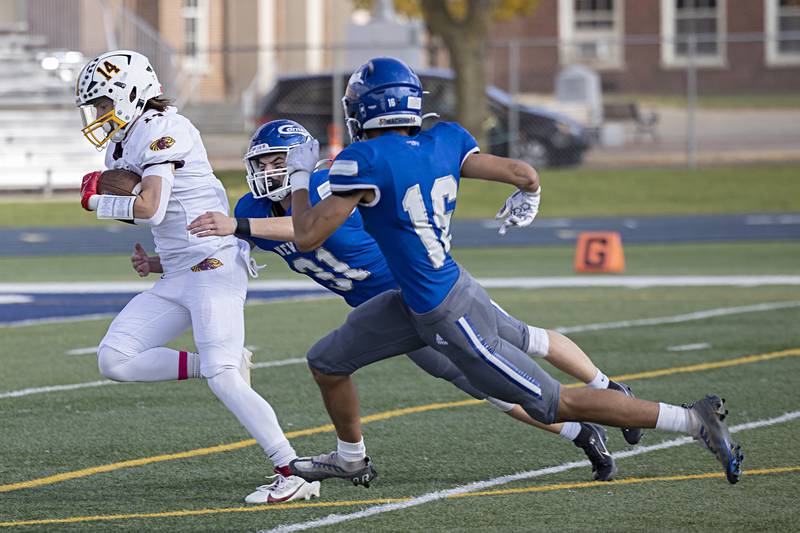 ROWVA’s Jack Godsil is chased down by Newman’s Cody McBride and Isaiah Williams Saturday, Oct. 28, 2023 in the Class 1A playoffs in Sterling.