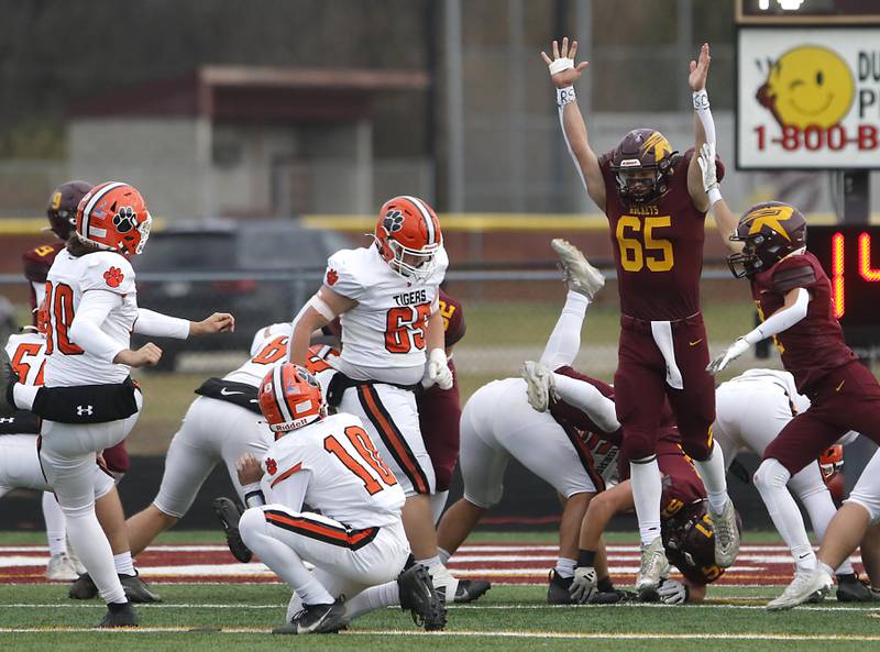 Richmond-Burton's Trevor Szumanski and Richmond-Burton's Joseph Larsen triy to block a Byron extra point during an IHSA Class 3A semifinal playoff football game on Saturday, November 22, 2025, at Richmond-Burton High School, in Richmond.
