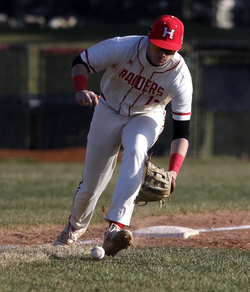 Huntley's Anthony (AJ) Putty fields a ball that was hit down the third base line during a Fox Valley Conference baseball game against McHenry on Friday, April 11, 2025, at Huntley High School.