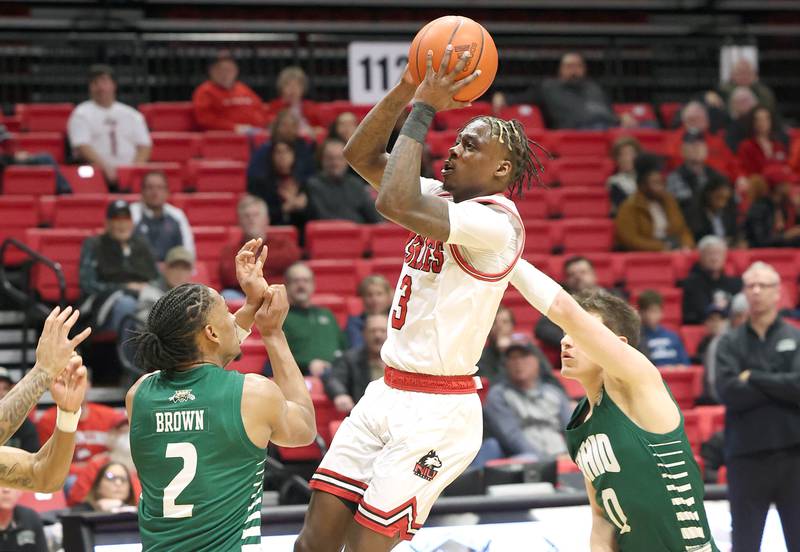 Northern Illinois Huskies guard Kaleb Thornton gets off a shot between two Ohio defenders during their game Tuesday, Feb. 7, 2023, in the Convocation Center at NIU in DeKalb.