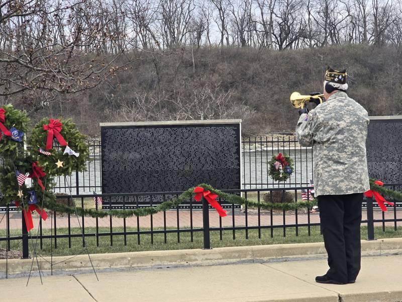 Glenn Bravanski of Marseilles VFW performs taps Saturday, Dec. 14, 2024, at the Middle East Conflict Wall in Marseilles in honor of those who died while serving during the Wreaths Across America event.