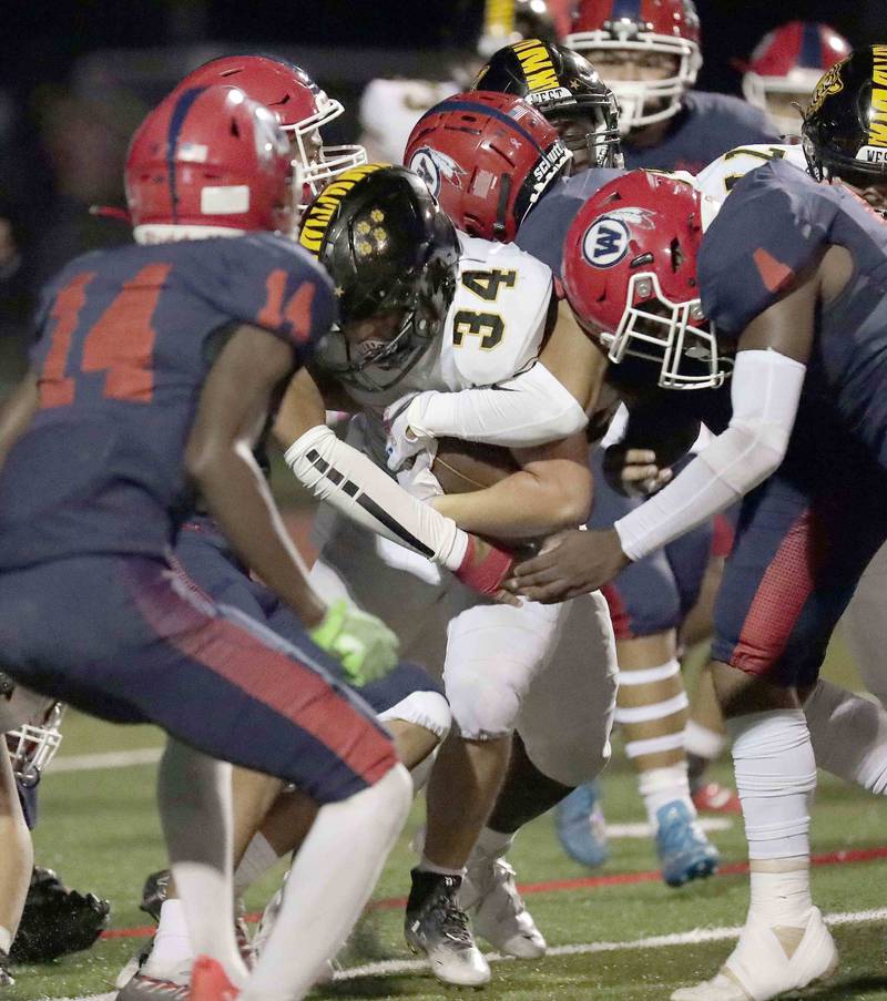 Joliet West’s John Wyzkowski (34) looks for running room against  West Aurora Thursday September 15, 2022 in Aurora.