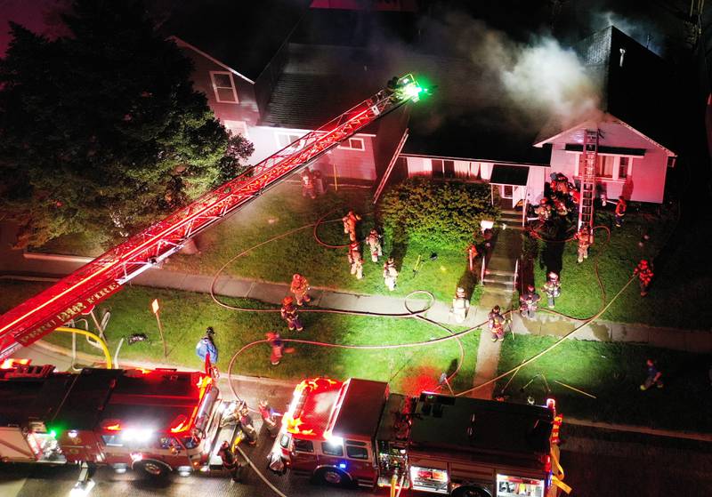 Firefighters work the scene of a structure fire in the 100 block of West Cleveland Street on Thursday, May 15, 2025 in Spring Valley. The fire broke out shortly before 8:30p.m. Fire departments from La Salle Bureau and Putnam Counties responded to the scene. One firefighter was injured at the scene. A mutual aid box alarm system (MABAS) call was issued prompting the response.