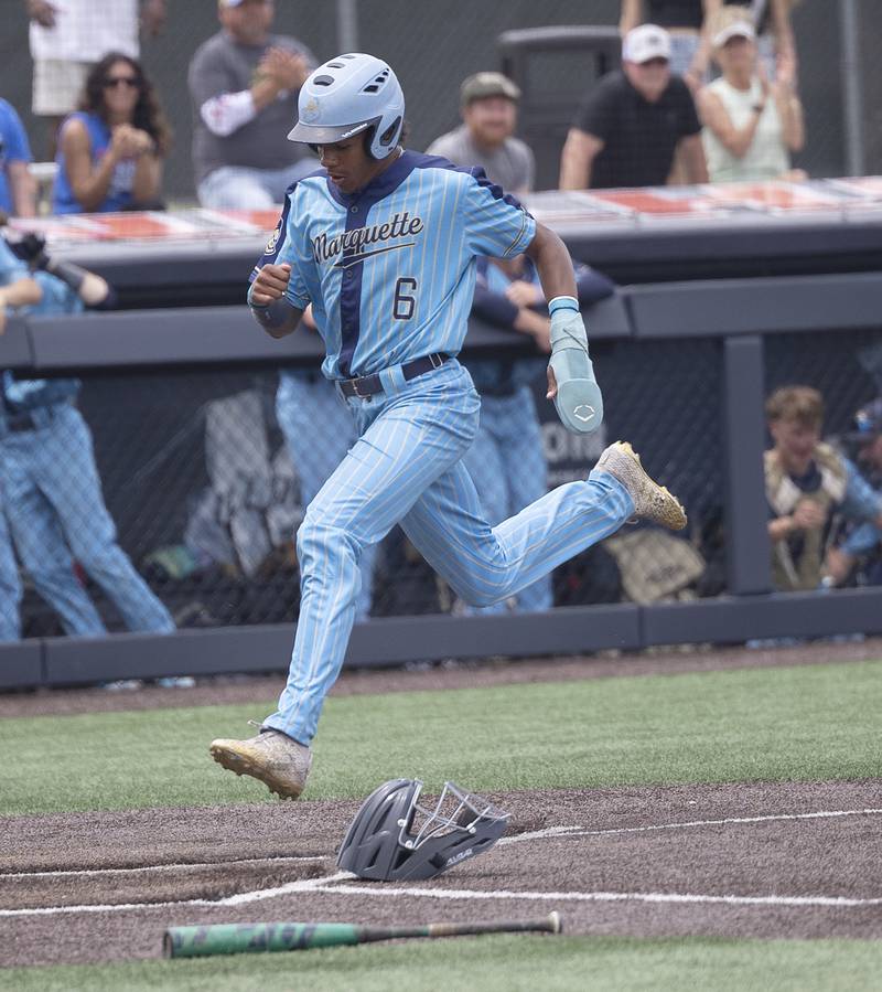 Ottawa Marquette’s Connor Baker crosses the plate against Father McGivney Saturday, June 7, 2025, during the Class 1A state baseball final at Illinois Field in Champaign.