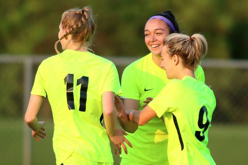 From left, Richmond-Burton’s Margaret Slove, Brianna Maldanado and Reese Frericks celebrate a Frericks goal against Willows in Class 1A Sectional title soccer action at Richmond Friday night.